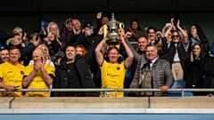 Dean Holden, captain of the Legends team, holding aloft the trophy after last year's charity game, which raised over £80,000