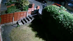 Images show a hooded figure holding a car theft ‘bridging device’ outside a house