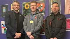 Ben Blackledge, Interim CEO of WorldSkills UK, is pictured with Joseph Brooks, Graphic Design Apprentice at Oldham College and Gold Medal winner 2022, and his employer, Lee Morris of Rhino Group