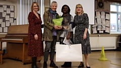 Patricia Stennet (centre, right) pictured being presented with flowers by Gina Andrewes, Chair of Broadfield's Governors