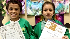 Greenacres Primary Academy pupils show off the school's certificates