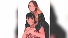 Pictured is Michelle (sat down) with her daughter