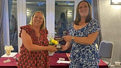 Pictured is Pam Taylor receiving her prize from Saddleworth Lady Captain Kaye Orme