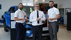 Staff at Oldham Volkswagen celebrate with a 20th anniversary cupcake