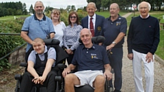 Pictured are (front row, in chairs): recipient Joseph Green and Paul Tennant, Scroungers Captain. Back row (left to right): Father Alan, Mother Sarah, Gail Taylor (Lady Captain, C+R), Dion Norbury (Captain, C+R), Syd Barton (Scroungers charity representative) and Peter Mitchell (wheelchair centre)