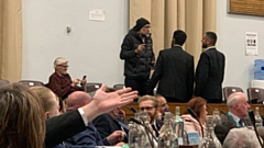 A protestor interrupts the Oldham council budget meeting