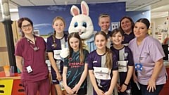 Smiles all round: The Santos Sharks under-12s girls' football team players pictured at the hospital