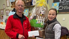 Pictured are Dr Andy Taylor, O M R Team Doctor, and Martha Tibbot, Shop Manager (and the giant chocolate egg)