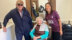 Mavis (centre) was an avid Latics supporter. Image courtesy of OMBC