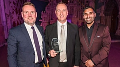 Pictured are Dave Cole, Head of HR at LWC, accepting the award alongside Baasit Siddiqui, host of this year’s GM Skills Awards (right), and David Lee, Sales Manager, Enterprise Learning and Skills (England) at Pearson U (left)