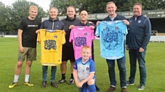 Inspiral Carpets trio Graham Lambert, Martyn Walsh and Stephen Holt show off the new Uppermill FC shirts at Seel Park