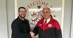 Dale Harris is welcomed back to Chadderton FC by club chairman Bob Sopel
