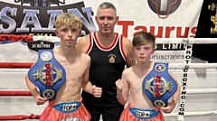 Isaan Head Coach Ste Donnelly is pictured (centre) with two of his young fighters